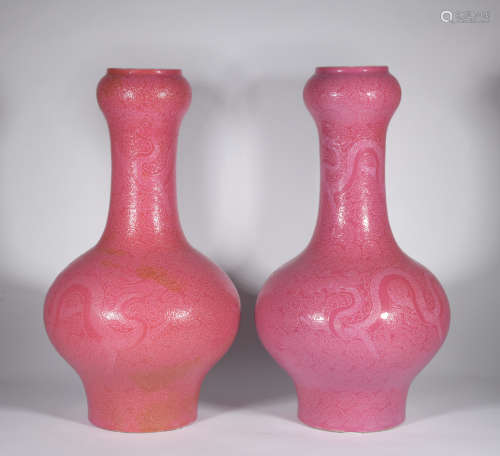 A pair of red glazed 'dragon' vase