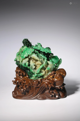 A Chinese green emerald jade carving of fish in a pond