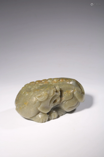 A Chinese green celadon jade carving of a lion