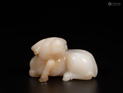 A Chinese white and russet jade carving of an ox