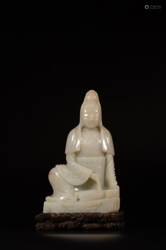 A Chinese celadon jade carving of a seated Guanyin