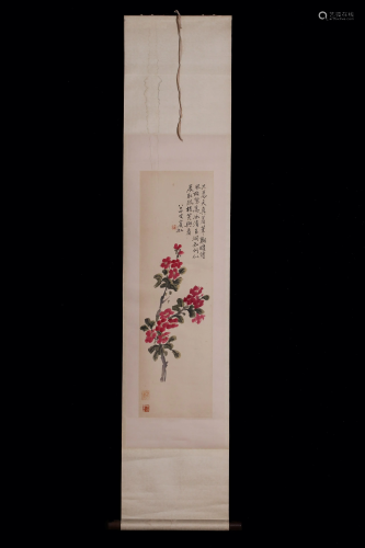 A Chinese scroll of flowers and calligraphy