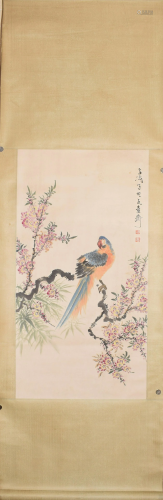 A Chinese scroll of a parrot on peony branches