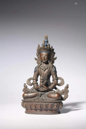 A Chinese bronze seated Buddha on a lotus base