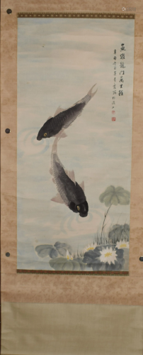 A Chinese scroll depicting fish in a lotus pond