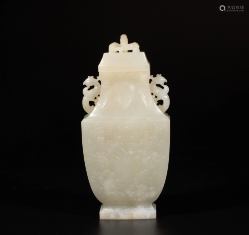 A Chinese carved white jade miniature vase and cover