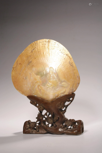 A Chinese shell centerpiece with carving of Guanyin