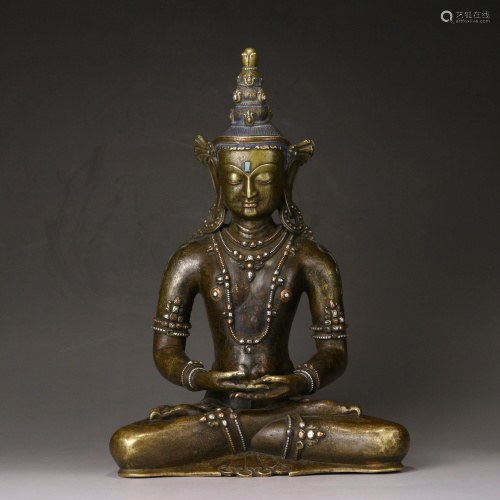 A copper alloy and silver figure of a Bodhisattva