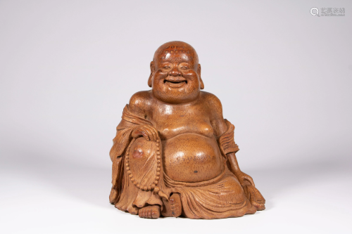A Chinese bamboo figure depicting smiling Buddha
