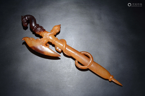 A Chinese russet jade carving of a ritual axe