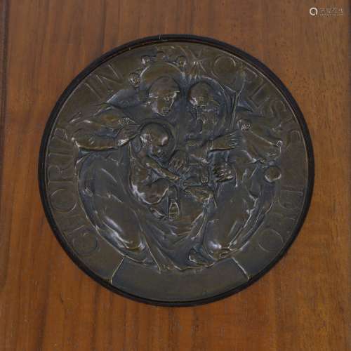 A circular relief moulded pressed bronze plaque, inscribed G...