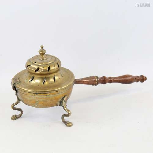 A 19th century brass chestnut roasting pan with wooden handl...