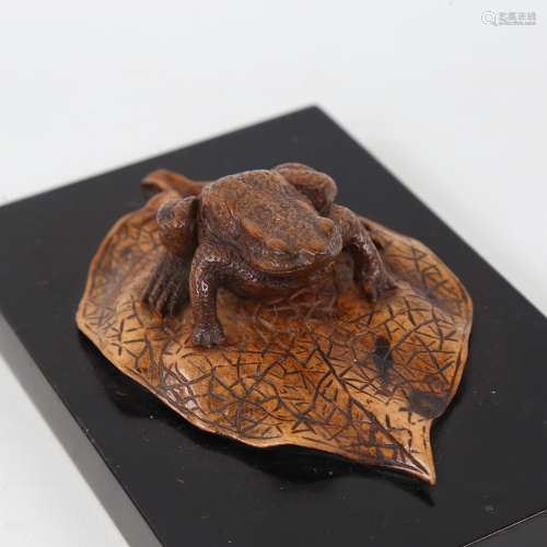 A carved stained wood frog on a leaf desk ornament, 18th or ...