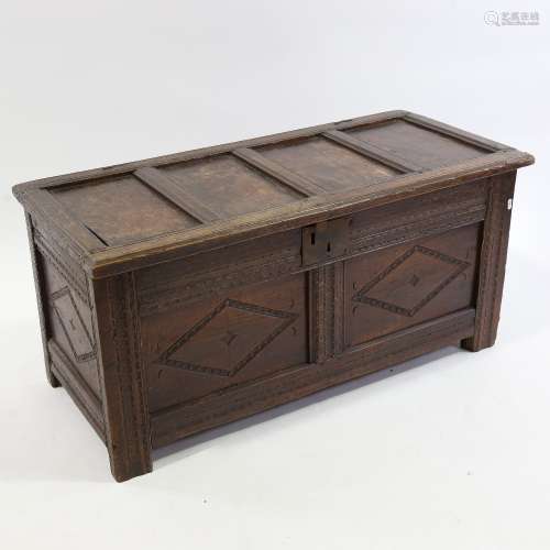 An 18th century carved and panelled oak coffer, length 10c7m...