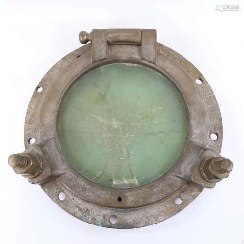 A large bronze ship's porthole, original from the steam yach...