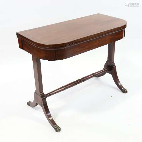 A Regency mahogany fold over card table on stretcher base, w...