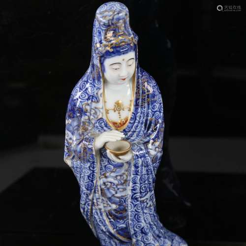 A Chinese blue and gilt decorated porcelain standing figure,...