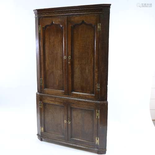 An 18th century oak 4-door floor standing corner cupboard, w...