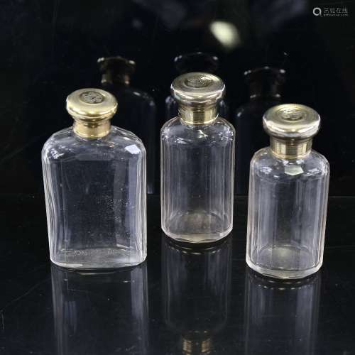 A set of 3 Asprey's cut-glass and silver-gilt topped perfume...