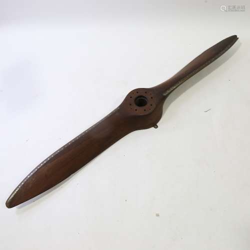 A Vintage laminate wood aircraft propeller, with riveted met...