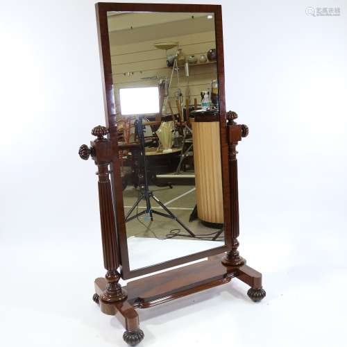 A Victorian mahogany-framed cheval mirror, with melon carved...