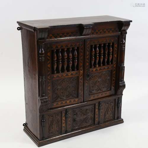A small 19th century carved and panelled oak wall-hanging cu...