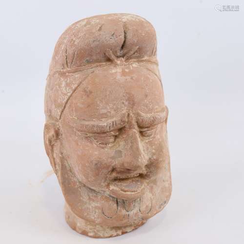 An Indian/Chinese terracotta life-size head wearing a turban...