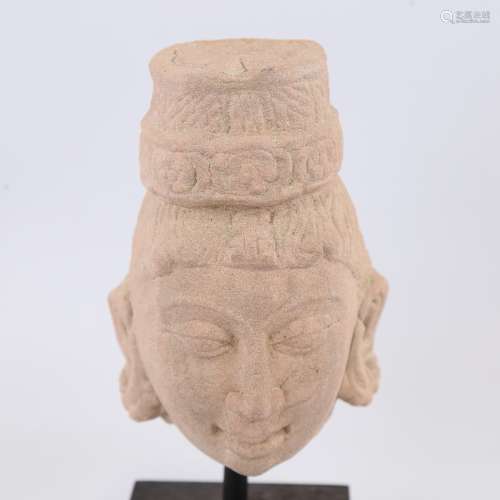 An Indian carved red stone head of a goddess, modern block p...