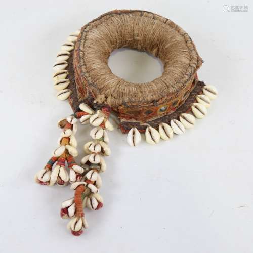 A Tribal armband decorated with cowrie shells