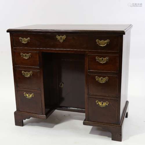 A George III mahogany kneehole writing desk of small size, w...