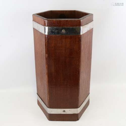 A 1930s oak stick stand of hexagonal form, by Lister & Co, w...