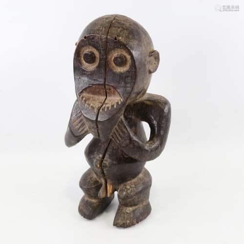An African carved and stained wood fertility figure, height ...