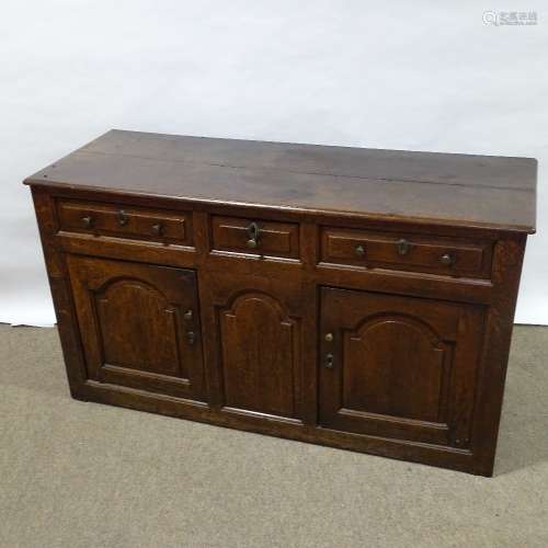 An 18th century oak dresser base, with fielded panelled cupb...