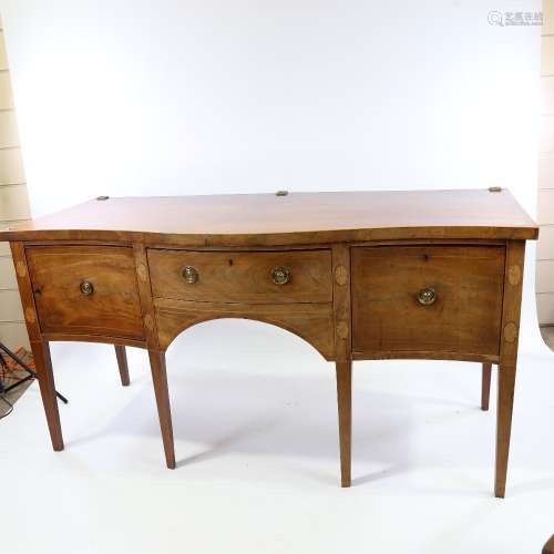 A George III mahogany serpentine-front sideboard, with brass...