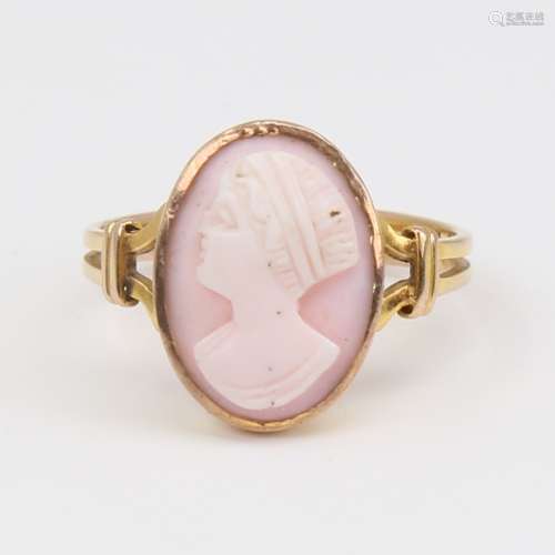 An unmarked gold relief carved pink coral cameo ring, depict...