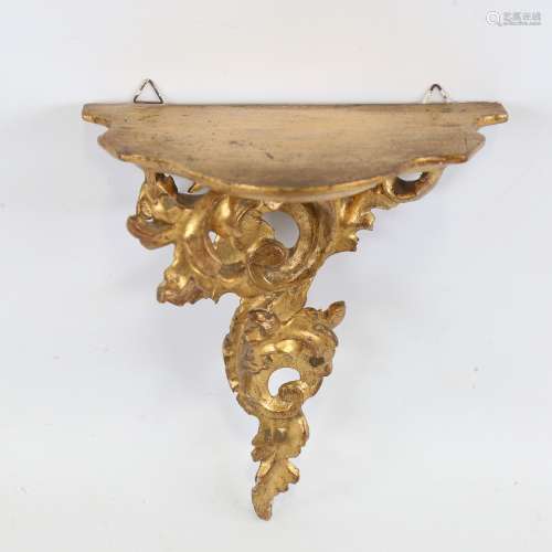 A carved giltwood Florentine shelf bracket with acanthus sup...