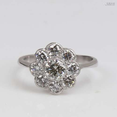 An unmarked white gold diamond cluster flowerhead ring, set ...
