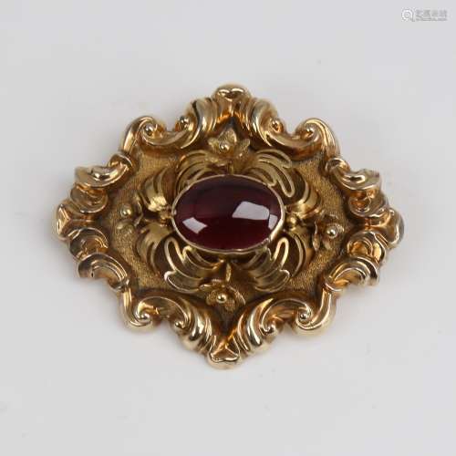 A Victorian unmarked gold cabochon garnet brooch, relief fol...
