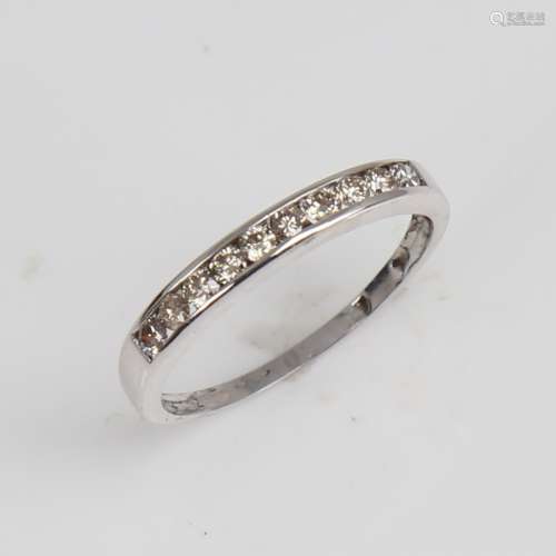 A modern 9ct white gold diamond half eternity ring, set with...