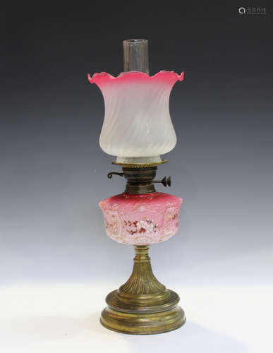 A late Victorian pink glass and brass table oil lamp, height...