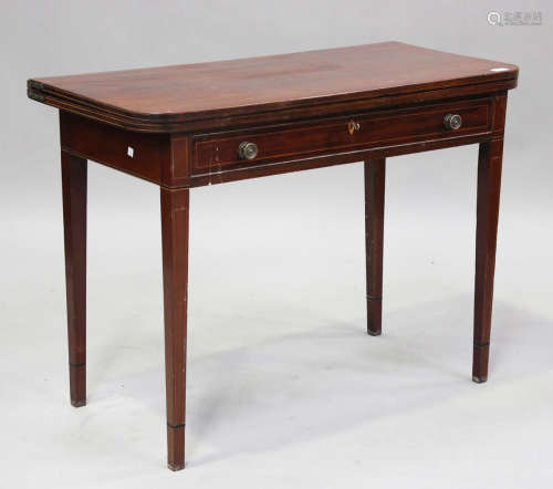 A George III mahogany fold-over tea table with boxwood strin...