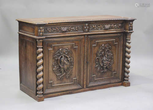 A late Victorian oak sideboard, carved with leaves, foliage ...