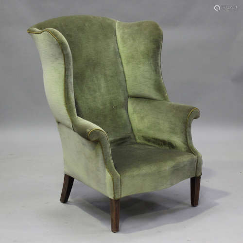 A 19th century wing back armchair, upholstered in green velo...
