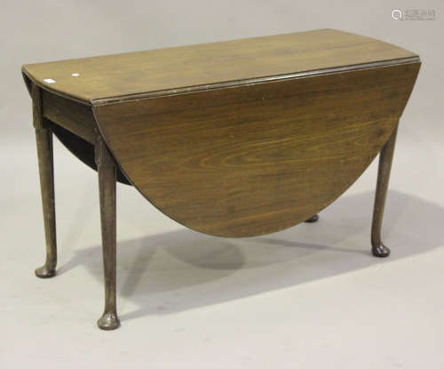 A 19th century mahogany oval drop-flap dining table, raised ...