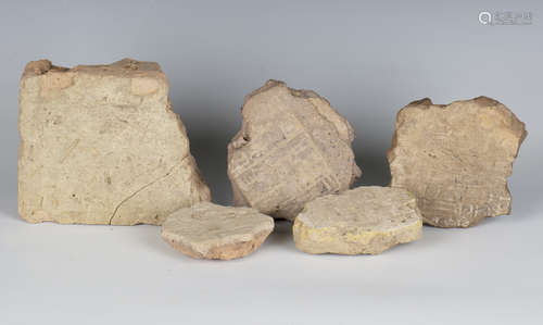 A group of five Babylonian clay brick fragments, all bearing...