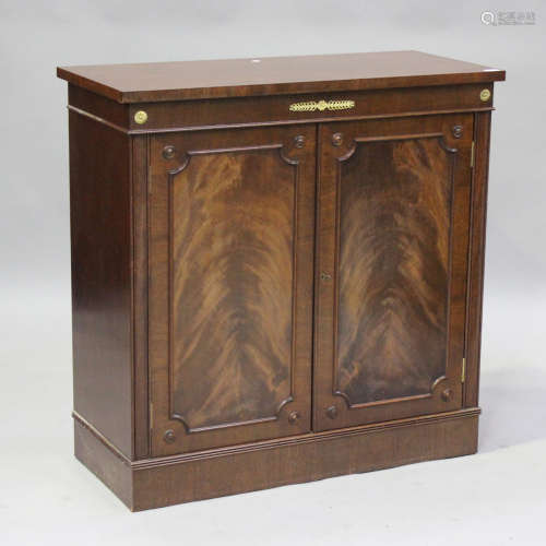 A late 20th century Empire style mahogany side cabinet with ...