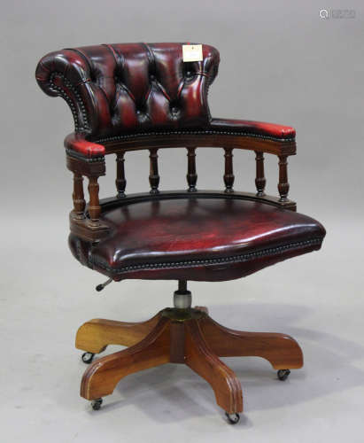A 20th century reproduction revolving office chair, upholste...