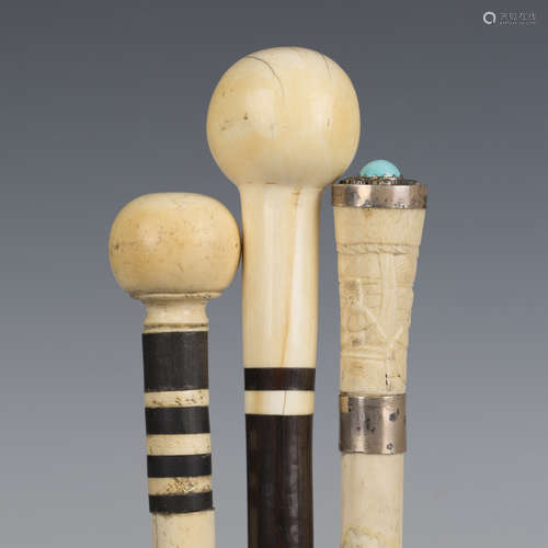 An early 20th century rosewood walking cane with an ivory bu...