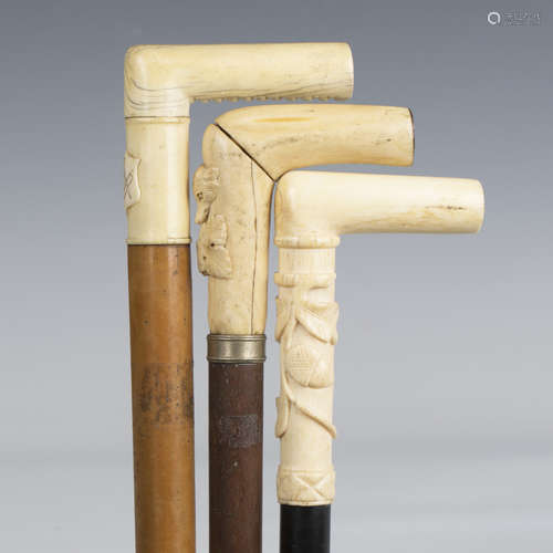 A late 19th century ebonized walking cane, the ivory handle ...