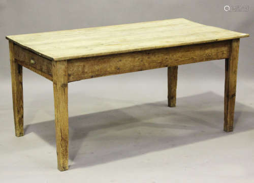 An early 20th century stripped pine kitchen table, fitted wi...